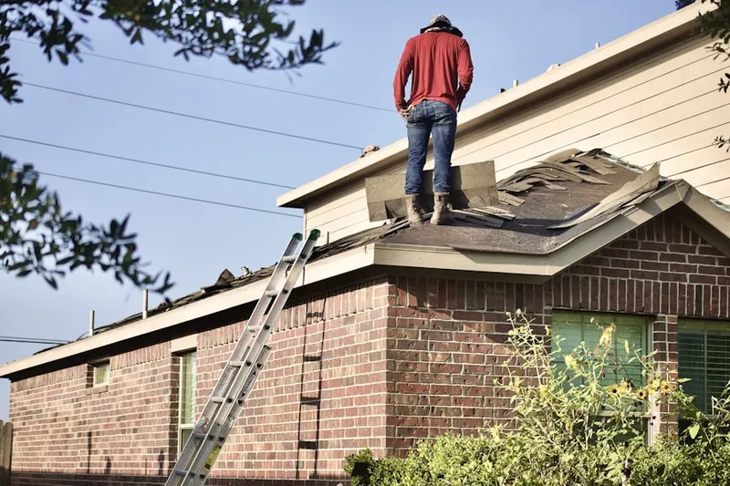 Professional roofer working on a residential roof in Deer Park